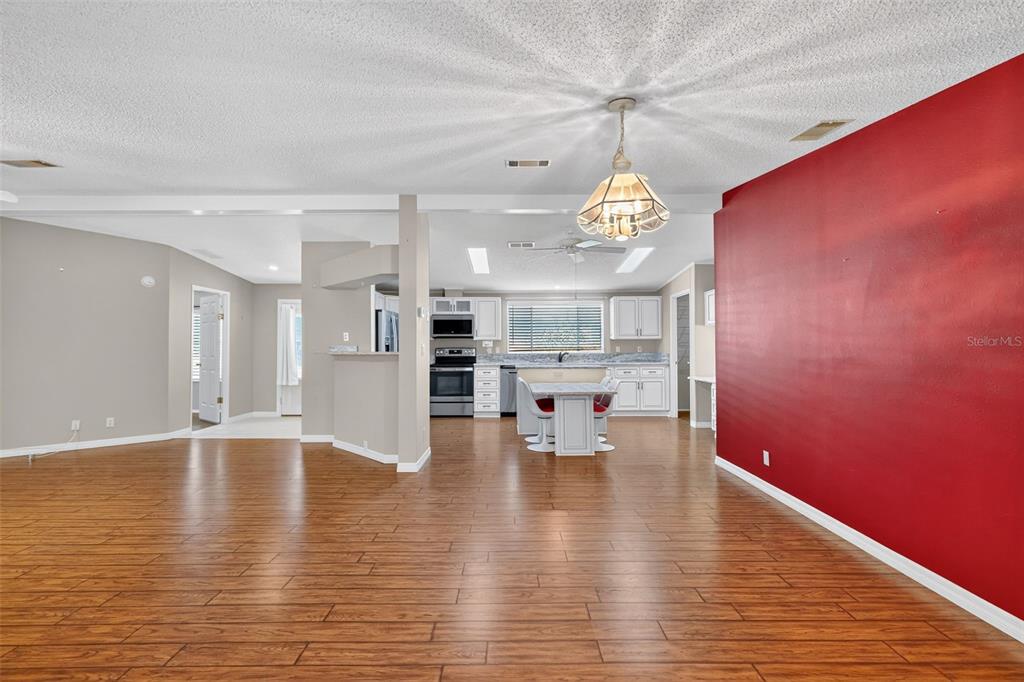 3024 Manatee Road Tavares, FL 32778 - Photo 5 of 39 a view of kitchen and dining room with wooden floor