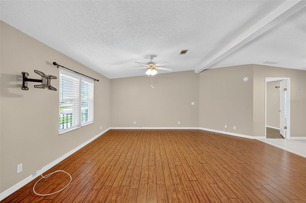 3024 Manatee Road Tavares, FL 32778 - Photo 6 of 39 a view of an empty room with wooden floor and a window