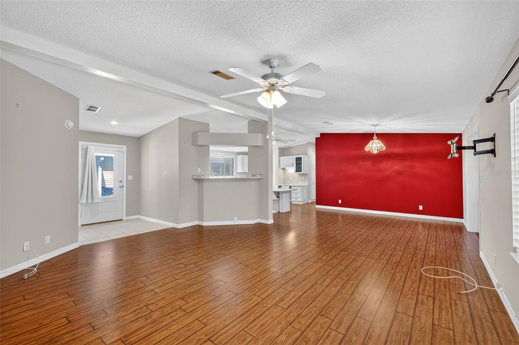 3024 Manatee Road Tavares, FL 32778 - Photo 7 of 39 a view of empty room with wooden floor and fan