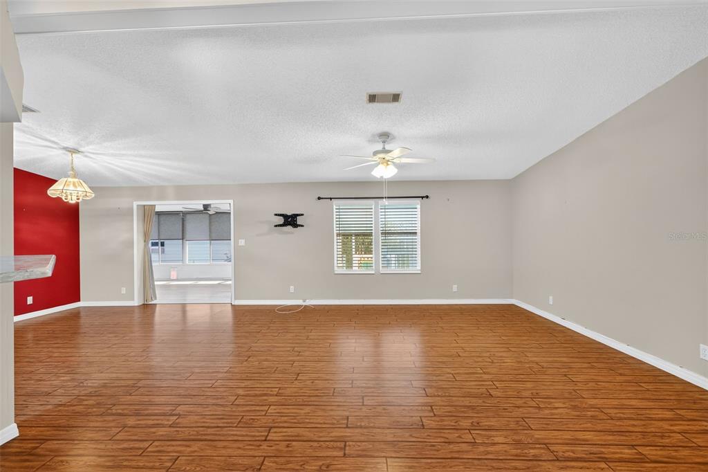 3024 Manatee Road Tavares, FL 32778 - Photo 8 of 39 a view of an empty room with wooden floor and a window