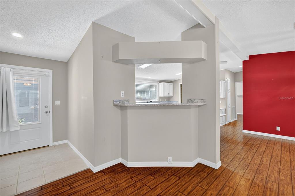 3024 Manatee Road Tavares, FL 32778 - Photo 9 of 39 an empty room with wooden floor and mirror