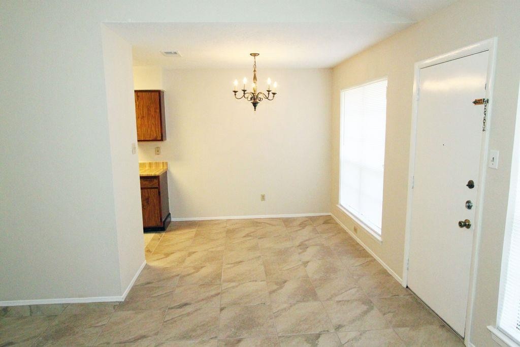 4627 Tealgate Drive Spring, TX 77373 - Photo 3 of 7 a view of a hallway with wooden floor and a living room