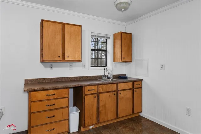 a utility room with mirror and a wooden floor