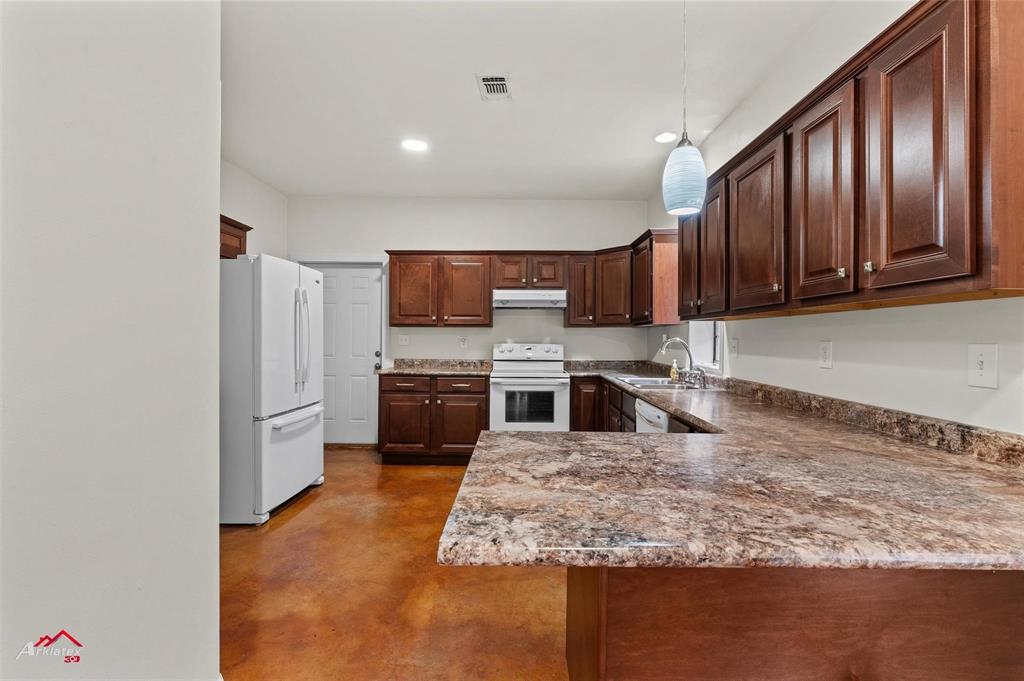 2912 Jamerson Road Haughton, LA 71037 - Photo 32 of 37 a kitchen with wooden cabinets and stainless steel appliances