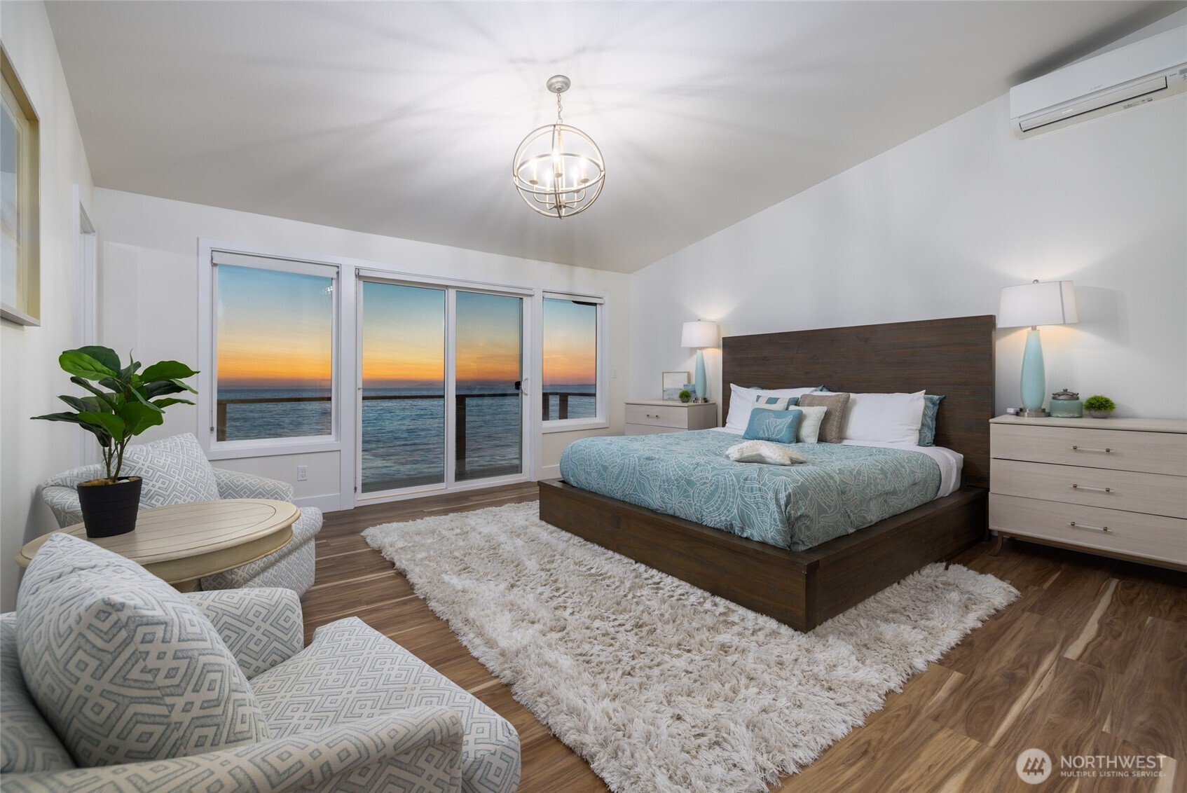 2575 West Beach Road Oak Harbor, WA 98277 - Photo 26 of 40 a bedroom with a large bed and a potted plant