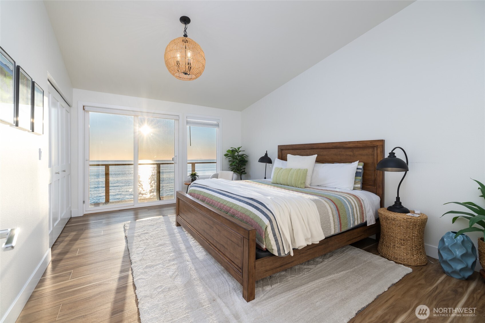 2575 West Beach Road Oak Harbor, WA 98277 - Photo 32 of 40 a spacious bedroom with a bed and a chandelier