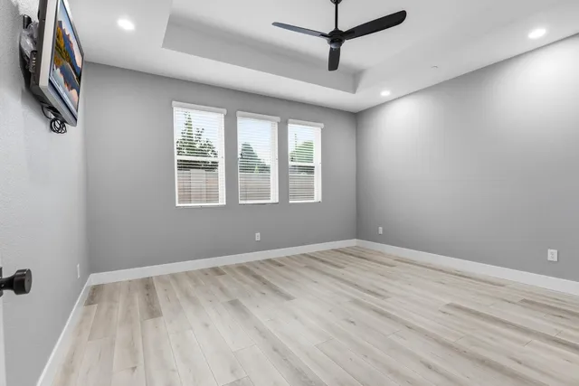 wooden floor in an empty room with a window