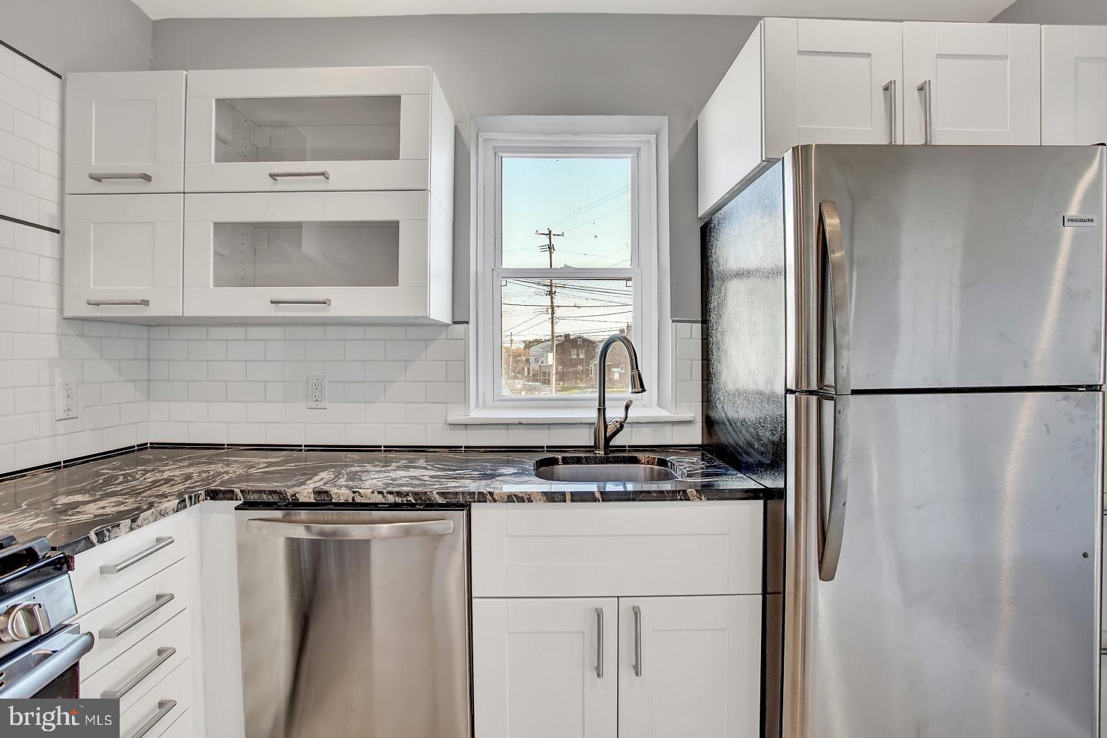 211 South Springfield Road Clifton Heights, PA 19018 - Photo 11 of 24 a kitchen with stainless steel appliances granite countertop a refrigerator and a stove