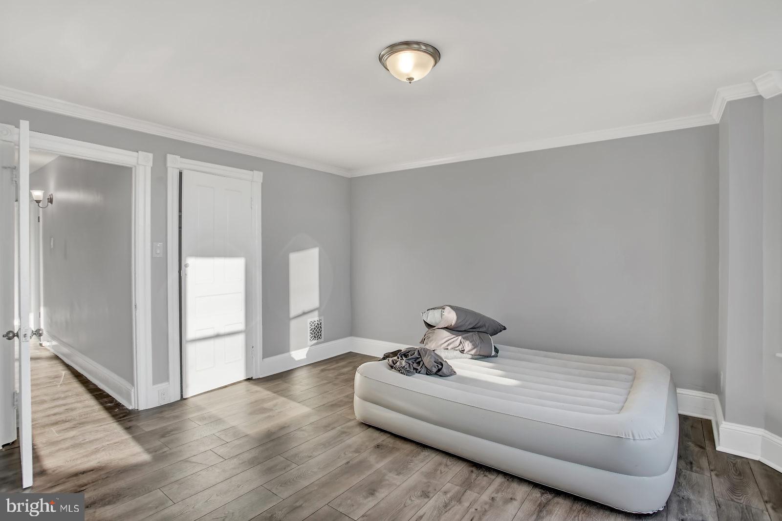 211 South Springfield Road Clifton Heights, PA 19018 - Photo 17 of 24 a bedroom with a bed and wooden floor