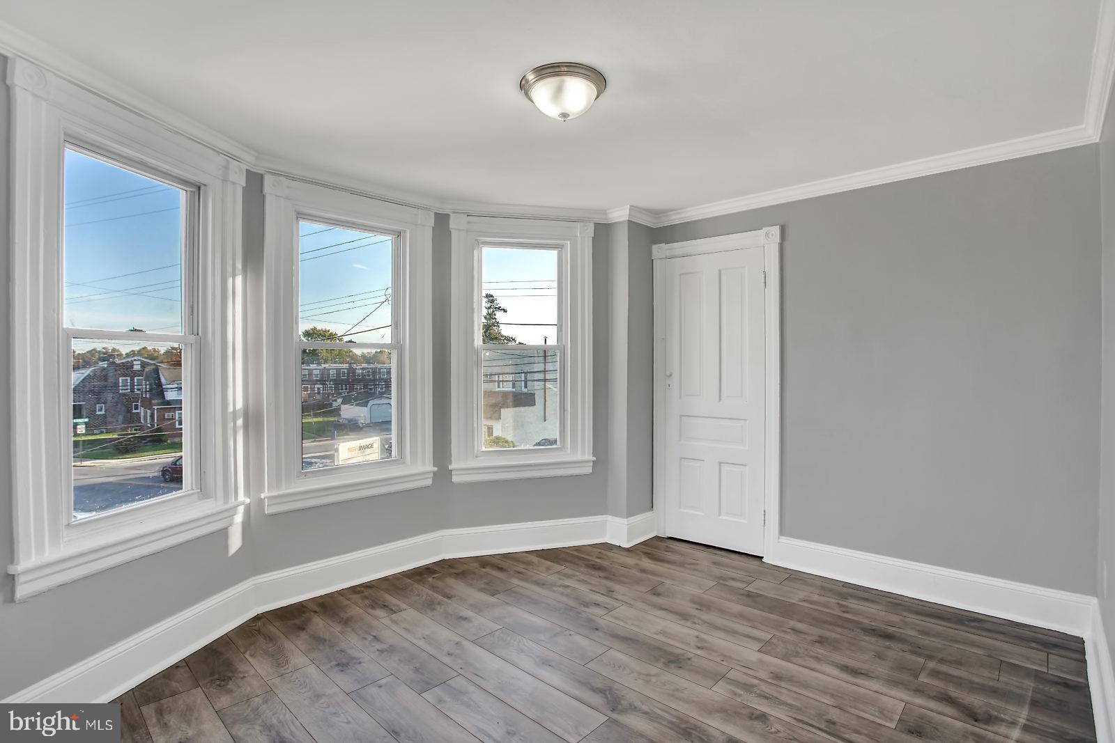 211 South Springfield Road Clifton Heights, PA 19018 - Photo 18 of 24 an empty room with wooden floor and windows