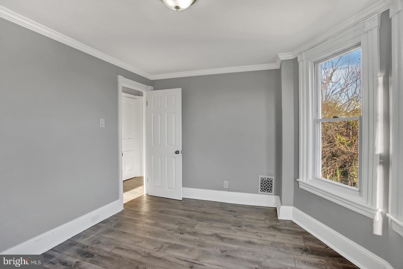 211 South Springfield Road Clifton Heights, PA 19018 - Photo 19 of 24 a view of an empty room with wooden floor and a window