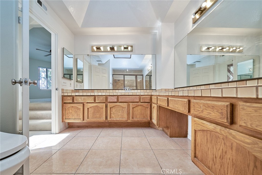 4431 Emerald Street Torrance, CA 90503 - Photo 11 of 31 a large white kitchen with cabinets and chairs