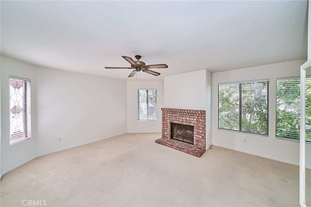4431 Emerald Street Torrance, CA 90503 - Photo 13 of 31 wooden floor fireplace and windows in an empty room