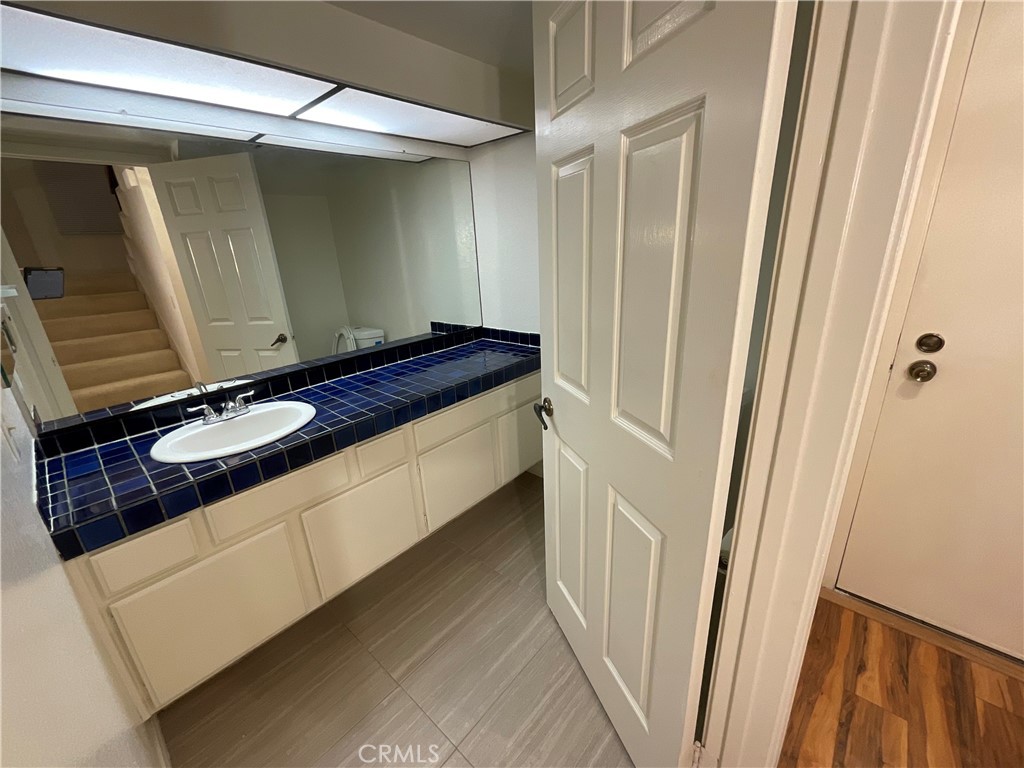 4431 Emerald Street Torrance, CA 90503 - Photo 21 of 31 a bathroom with a granite countertop sink and a mirror