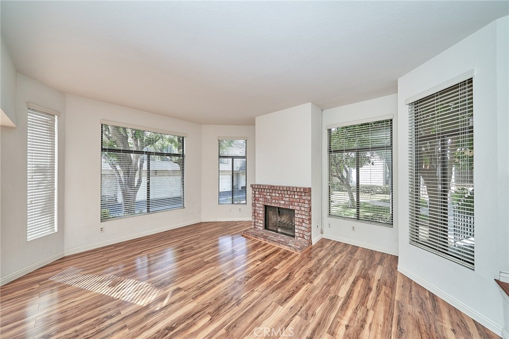 4431 Emerald Street Torrance, CA 90503 - Photo 5 of 31 a view of empty room with wooden floor and fireplace