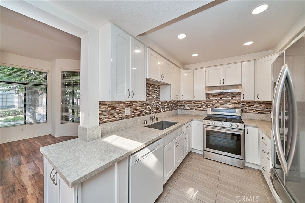 4431 Emerald Street Torrance, CA 90503 - Photo 8 of 31 a kitchen with a sink stove oven and refrigerator
