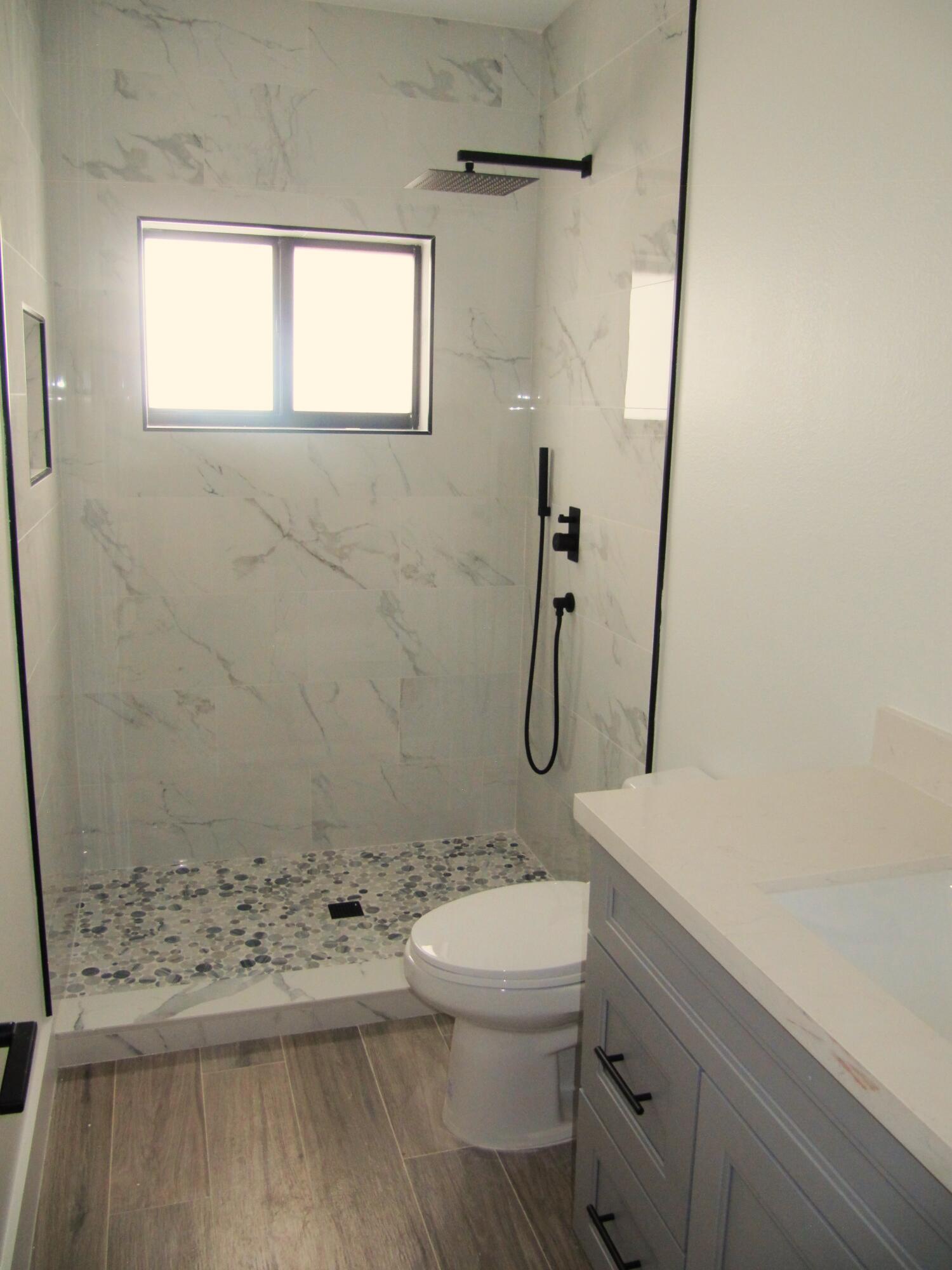 16 Tina Place Key Largo, FL 33037 - Photo 13 of 19 a bathroom with a granite countertop sink a toilet and a shower