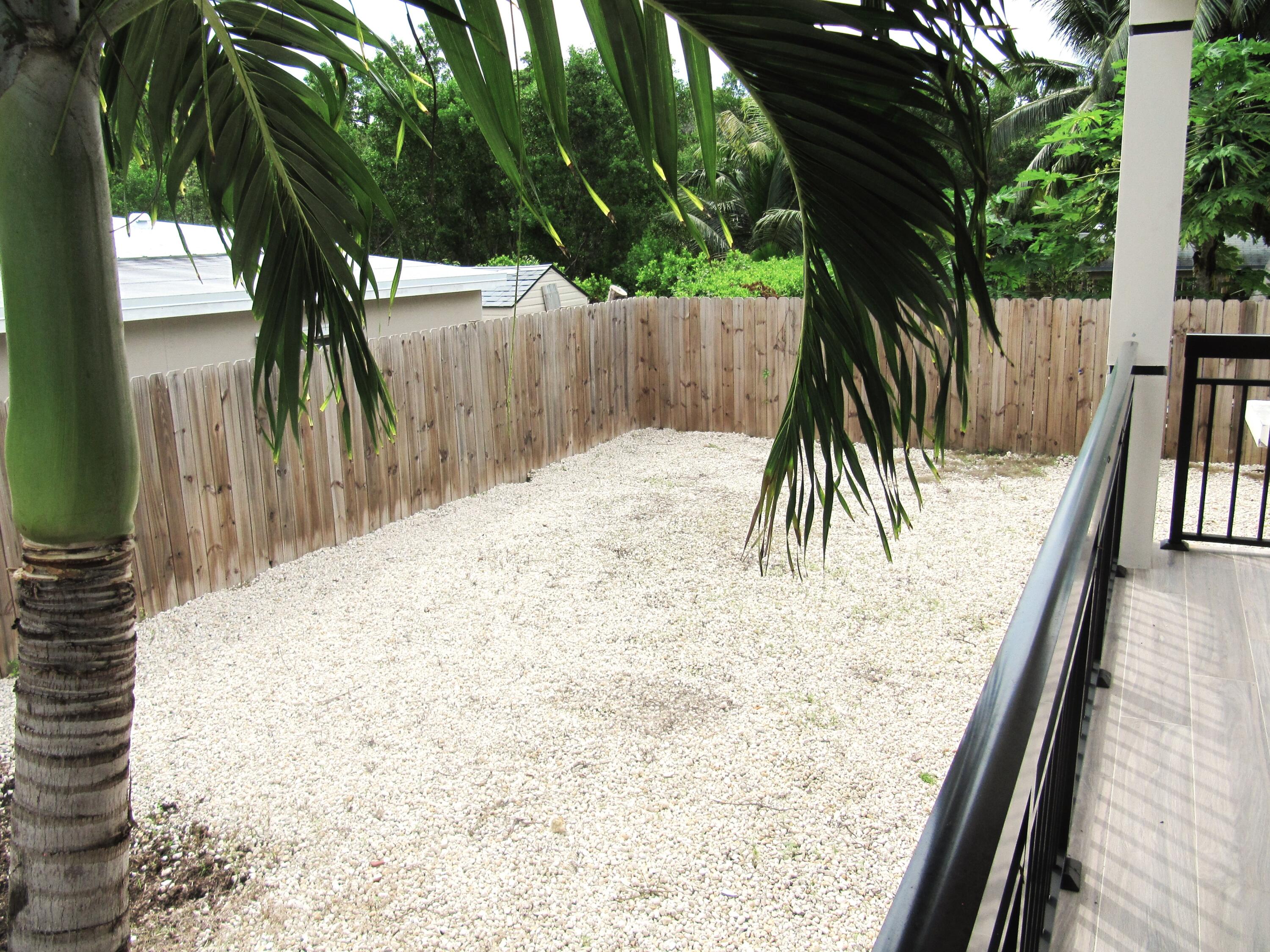 16 Tina Place Key Largo, FL 33037 - Photo 17 of 19 a view of balcony with wooden floor and fence