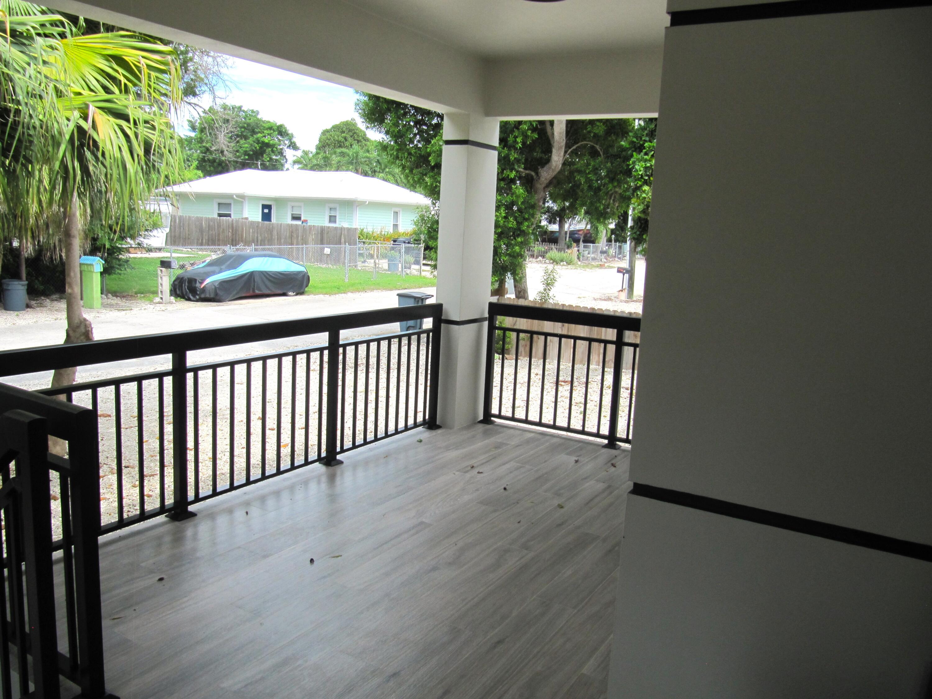 16 Tina Place Key Largo, FL 33037 - Photo 4 of 19 a view of a porch with wooden floor and outdoor space
