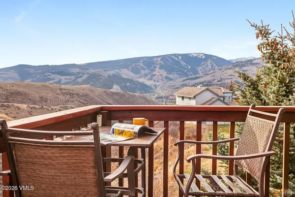 a view of a balcony with furniture and a mountain