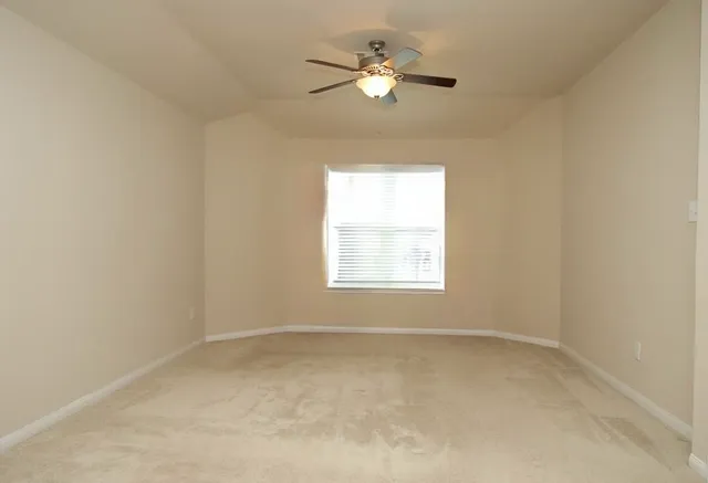 an empty room with windows and closet