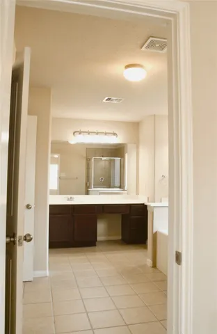 an empty room with a window and a chandelier fan