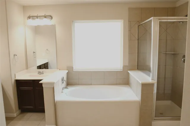 a view of bathroom with bathtub and shower