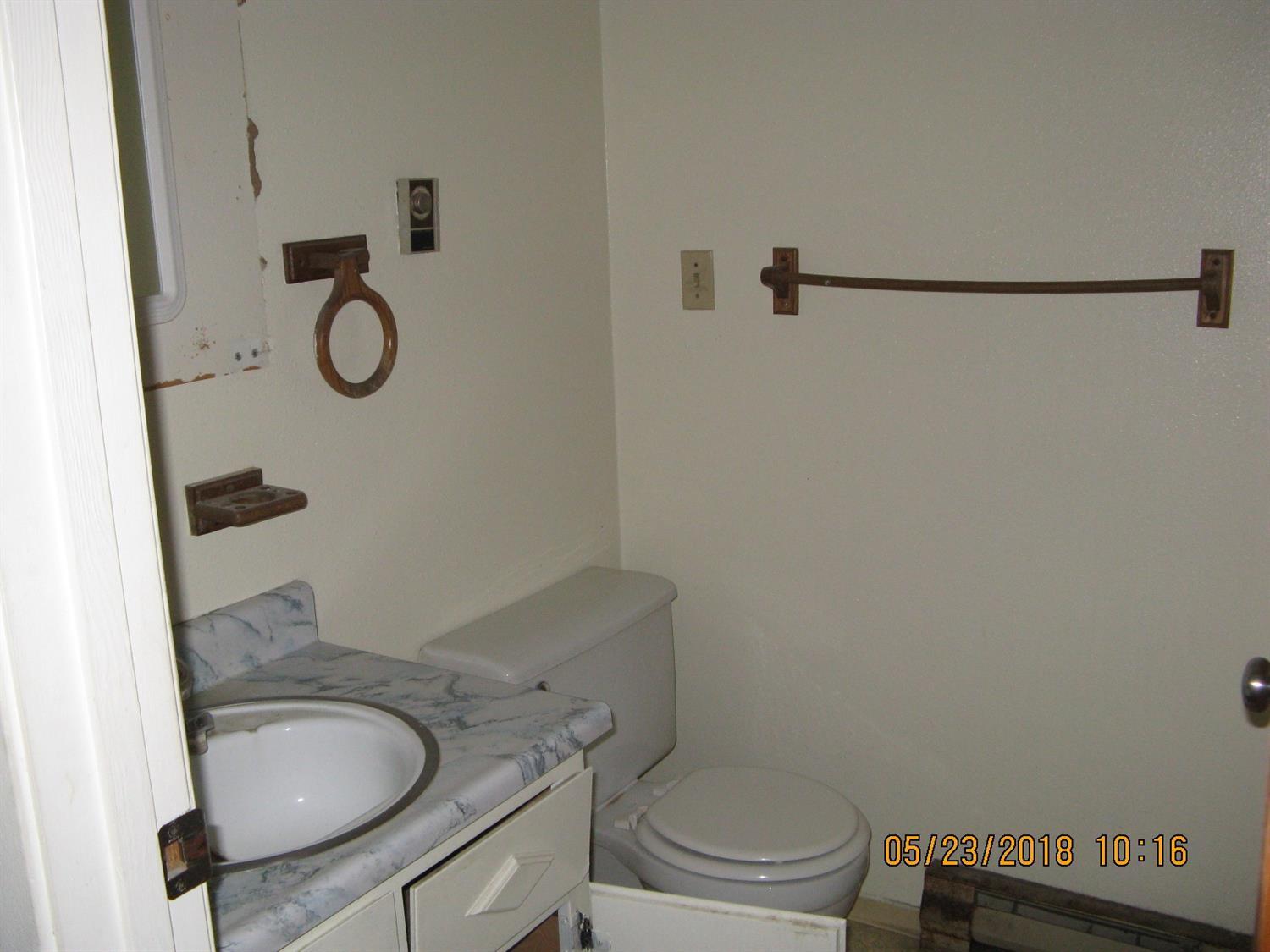 975 East Justice Road Central Point, OR 97502 - Photo 7 of 7 a bathroom with a granite countertop toilet sink and mirror