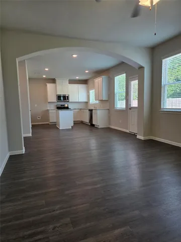 a view of a kitchen with furniture and wooden floor