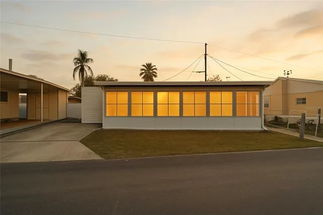 a view of a house with backyard and sitting area