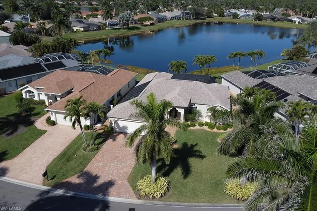 an aerial view of residential houses with outdoor space and swimming pool