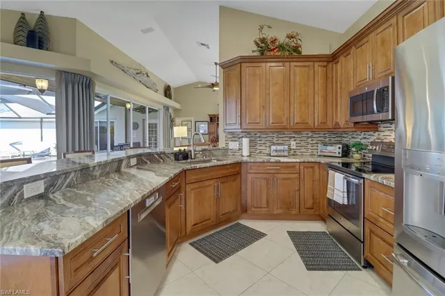 a kitchen with stainless steel appliances granite countertop a sink and cabinets