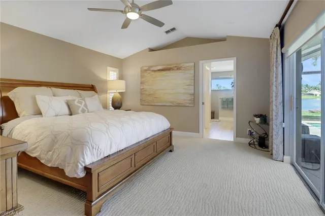 a spacious bedroom with a bed and a chandelier