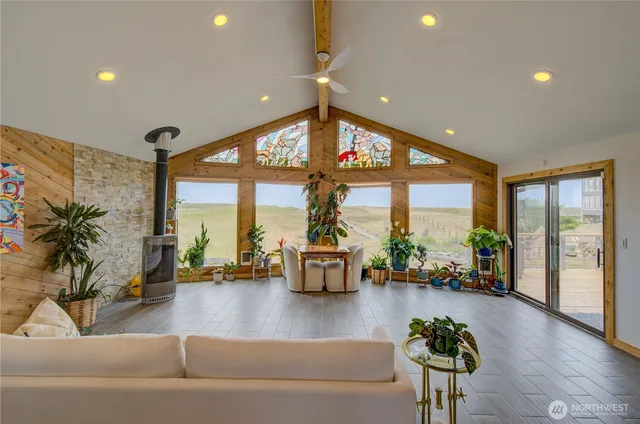 a living room with furniture and floor to ceiling window