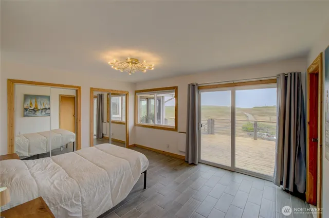 a spacious bedroom with a large bed and a large window