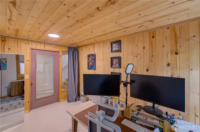 a desktop computer sitting on top of a desk and chair with wooden floor