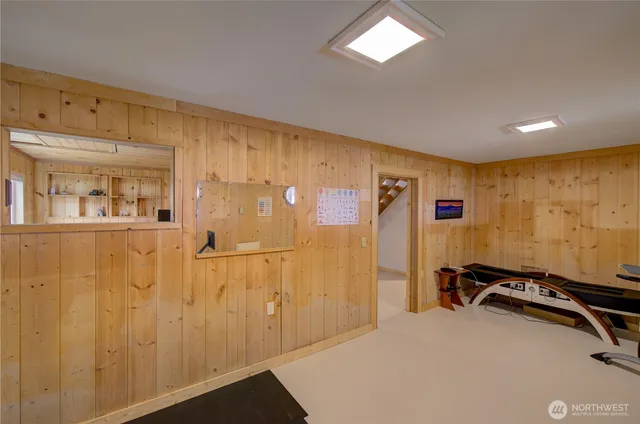 a bedroom with a bed and a mirror