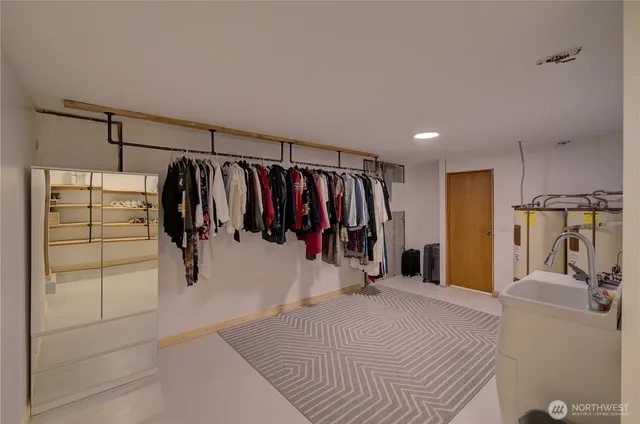 a view of walk in closet with clothes