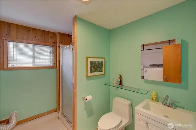 a bathroom with a toilet sink and mirror