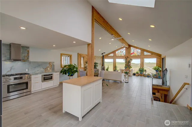 a kitchen with a table chairs stove and flat screen tv
