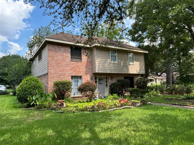 a front view of a house with a garden and plants
