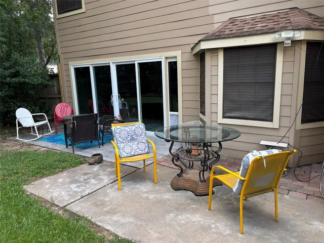 a view of a backyard with table and chairs