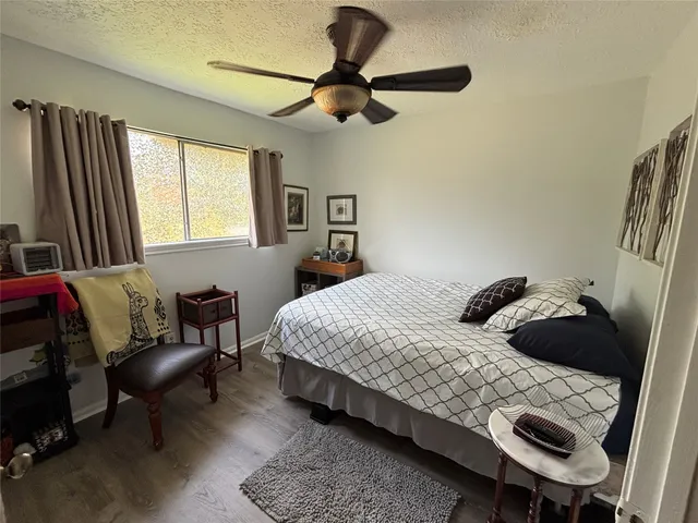 a bedroom with a bed a couch and a window