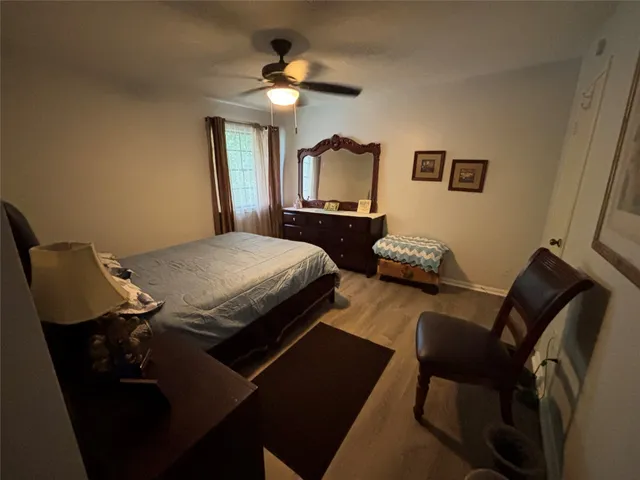 a bedroom with bed chair and window