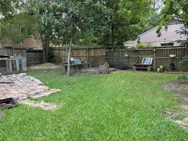 a view of backyard with house and outdoor seating