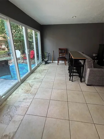 a living room with furniture and a floor to ceiling window
