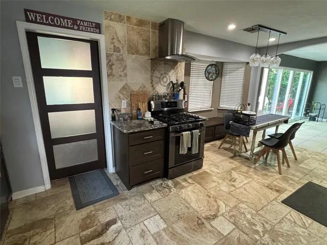 a kitchen with stainless steel appliances granite countertop a stove a refrigerator and a microwave