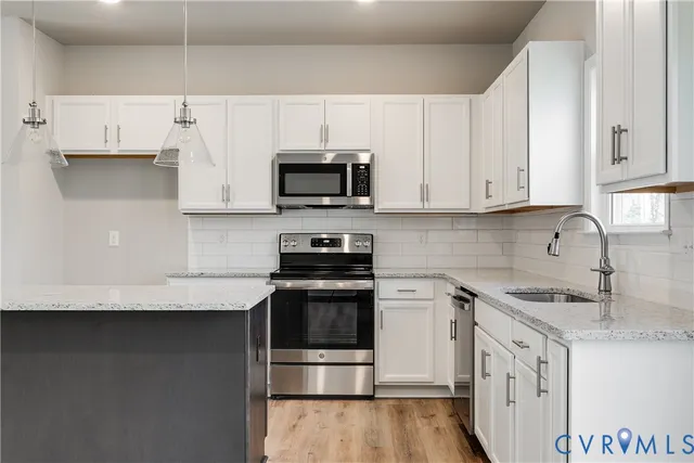 a spacious bedroom with a large bed couch and a window