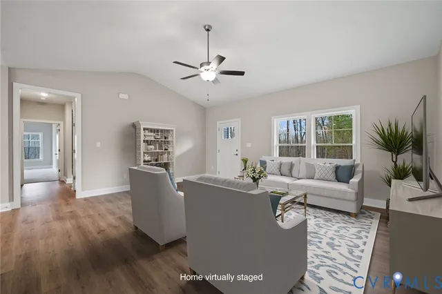 a living room with furniture potted plant and a flat screen tv