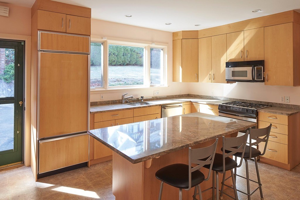 236 Buckminster Road Brookline, MA 02445 - Photo 4 of 8 a kitchen with a table chairs sink and cabinets